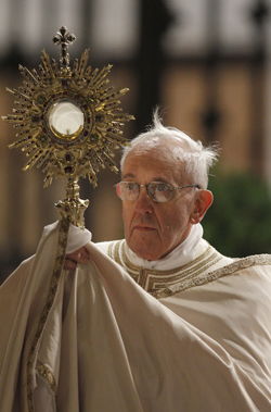 Pope Francis holds a monstrance during the observance of the feast of Corpus Christi at the Basilica of St. Mary Major in Rome May 30. (CNS photo/Paul Haring) (May 30, 2013) See POPE-CORPUSCHRISTI May 30, 2013.